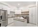 A well-organized laundry room with modern appliances, ample storage, and center island at 5803 Vintage Oak Ln, Raleigh, NC 27613