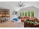 Spacious living room features a foosball table, a large couch, a wet bar, and large windows at 5803 Vintage Oak Ln, Raleigh, NC 27613
