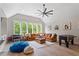 Bright living room boasts a foosball table, an oversized sectional sofa, a large window, and vaulted ceilings at 5803 Vintage Oak Ln, Raleigh, NC 27613