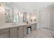 A luxurious main bathroom featuring dual vanities, multiple mirrors, and a walk-in shower at 5803 Vintage Oak Ln, Raleigh, NC 27613