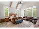 Bright primary bedroom with vaulted ceiling, exposed beams, a ceiling fan, and large windows at 5803 Vintage Oak Ln, Raleigh, NC 27613