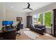 Well-lit home office features a ceiling fan, hardwood floors, a work space, and a cozy seating area at 5803 Vintage Oak Ln, Raleigh, NC 27613