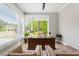 Well-lit home office with classic desk, comfortable seating, and serene views at 5803 Vintage Oak Ln, Raleigh, NC 27613
