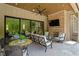 Inviting outdoor patio with cozy seating, fireplace, and a view of the backyard at 5803 Vintage Oak Ln, Raleigh, NC 27613