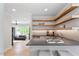 Stylish wet bar features a concrete countertop, floating wood shelves, mosaic backsplash, and plenty of counterspace at 5803 Vintage Oak Ln, Raleigh, NC 27613