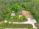 Aerial view of the property showing mature trees and landscaping surrounding the house at 615 Beaver Creek Rd, Apex, NC 27502
