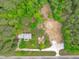 Drone eye-view of a secluded property nestled in a lush wooded area with expansive land at 615 Beaver Creek Rd, Apex, NC 27502