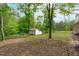 Expansive backyard features an outbuilding and ample space for outdoor activities and gatherings at 615 Beaver Creek Rd, Apex, NC 27502