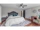 Bedroom with a king-sized bed, wood floors, ceiling fan, and an accent rug at 615 Beaver Creek Rd, Apex, NC 27502