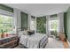 Well-lit bedroom showcasing neutral colored carpet, decorative pillows and houseplants at 615 Beaver Creek Rd, Apex, NC 27502