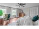 Bright bedroom featuring hardwood floors, neutral walls, windows, and an overhead ceiling fan at 615 Beaver Creek Rd, Apex, NC 27502