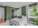 Comfortable bedroom features hardwood floors, large windows and houseplants at 615 Beaver Creek Rd, Apex, NC 27502