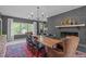 Elegant dining room with a striking brick fireplace and a rustic wooden table at 615 Beaver Creek Rd, Apex, NC 27502