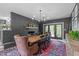 Dining room features a brick accent wall, fireplace and an elegant chandelier at 615 Beaver Creek Rd, Apex, NC 27502