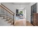 Entryway view of living room, featuring hardwood floors and classic staircase at 615 Beaver Creek Rd, Apex, NC 27502