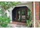 Charming entryway with double doors, brick accents, and decorative potted plants at 615 Beaver Creek Rd, Apex, NC 27502