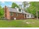 Back exterior view showcasing the brickwork and architectural features of the home at 615 Beaver Creek Rd, Apex, NC 27502