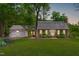 Charming brick home with a lush green lawn and a welcoming two-car garage at 615 Beaver Creek Rd, Apex, NC 27502