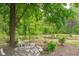Backyard garden area under the shade of a large tree at 615 Beaver Creek Rd, Apex, NC 27502
