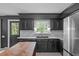 Updated kitchen with stainless steel appliances, white countertops and dark cabinetry at 615 Beaver Creek Rd, Apex, NC 27502