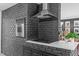 Updated kitchen with stainless appliances, stone backsplash, and a cooktop in a brick wall at 615 Beaver Creek Rd, Apex, NC 27502