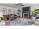 Cozy living room featuring a fireplace, modern decor, and comfortable leather seating at 615 Beaver Creek Rd, Apex, NC 27502
