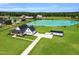 Stunning aerial view of a modern farmhouse with a large pond and lush green lawn at 6185 Nc-50, Benson, NC 27504