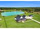 A beautiful modern farmhouse with a pond and forest in the background at 6185 Nc-50, Benson, NC 27504