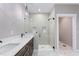 Bright bathroom featuring dual sink vanity, glass shower with tiled niche, and marble floors at 6185 Nc-50, Benson, NC 27504