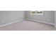 Bedroom with neutral carpet, double hung windows overlooking rural property, and neutral paint at 6185 Nc-50, Benson, NC 27504