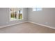 Carpeted bedroom with double hung windows and views of a covered porch and landscaped backyard at 6185 Nc-50, Benson, NC 27504