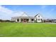 Beautiful modern farmhouse with a sprawling green lawn, featuring a classic covered porch at 6185 Nc-50, Benson, NC 27504