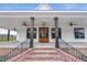 Charming front porch with wood columns, brick stairs, and a stylish wooden double-door entryway at 6185 Nc-50, Benson, NC 27504