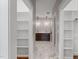 Hallway with built-in shelves leading to a modern bathroom with dual sinks and a glass shower at 6185 Nc-50, Benson, NC 27504