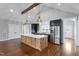 Bright open kitchen featuring stainless steel appliances and a large custom island at 6185 Nc-50, Benson, NC 27504