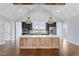Open kitchen with custom wood island, stainless appliances, and vaulted ceiling at 6185 Nc-50, Benson, NC 27504