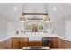 Spacious kitchen featuring a large island, modern appliances, and stylish pendant lighting at 6185 Nc-50, Benson, NC 27504