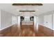 Open-concept kitchen and dining area features a large island, modern appliances, and hardwood floors at 6185 Nc-50, Benson, NC 27504