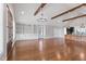 Open-concept living room featuring vaulted ceilings, hardwood floors, and custom built-in shelving at 6185 Nc-50, Benson, NC 27504