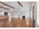 Spacious living room with hardwood floors, stone fireplace, and vaulted ceilings with exposed beams at 6185 Nc-50, Benson, NC 27504
