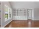 Bright living room with hardwood floors, built-in shelving, and large windows offering natural light at 6185 Nc-50, Benson, NC 27504