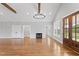 Bright living room featuring hardwood floors, a fireplace, and a stylish wooden-door entryway at 6185 Nc-50, Benson, NC 27504