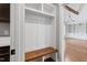 Mudroom area with built-in shelving, wooden bench and view of a living room at 6185 Nc-50, Benson, NC 27504