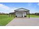 White outbuilding featuring a roll-up door and side shelter, providing ample space for storage or hobbies at 6185 Nc-50, Benson, NC 27504