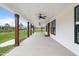Extended porch featuring dark-trimmed windows, ceiling fans, wood posts, and stylish outdoor living at 6185 Nc-50, Benson, NC 27504