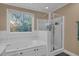Spacious bathroom featuring a large soaking tub and glass-enclosed shower at 6245 Hampton Ridge Rd, Raleigh, NC 27603