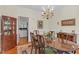 Traditional dining room showcasing a chandelier, wooden table with seating for six, and elegant decor at 6245 Hampton Ridge Rd, Raleigh, NC 27603