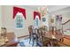 Formal dining room featuring a chandelier, large windows with red drapes, and a wood table at 6245 Hampton Ridge Rd, Raleigh, NC 27603