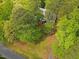 Aerial view of a charming home, nestled among lush greenery and mature trees at 6245 Hampton Ridge Rd, Raleigh, NC 27603
