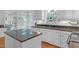 Bright kitchen with white cabinetry, stone countertops, and modern appliances at 6245 Hampton Ridge Rd, Raleigh, NC 27603